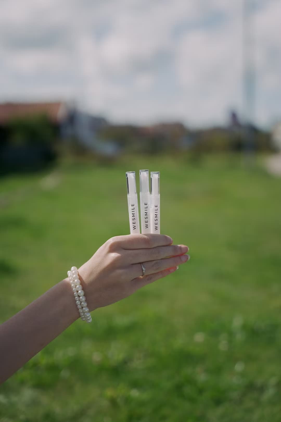 Three refill gel pens held up outdoors