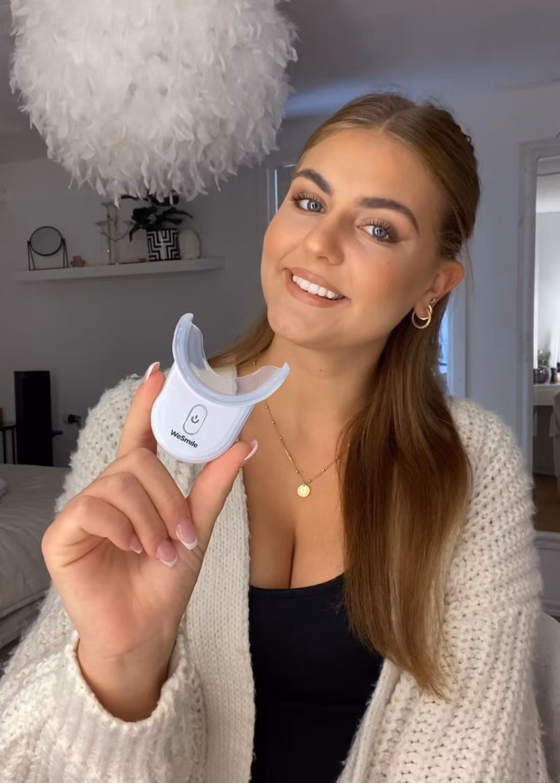 A woman using the LED booster at home