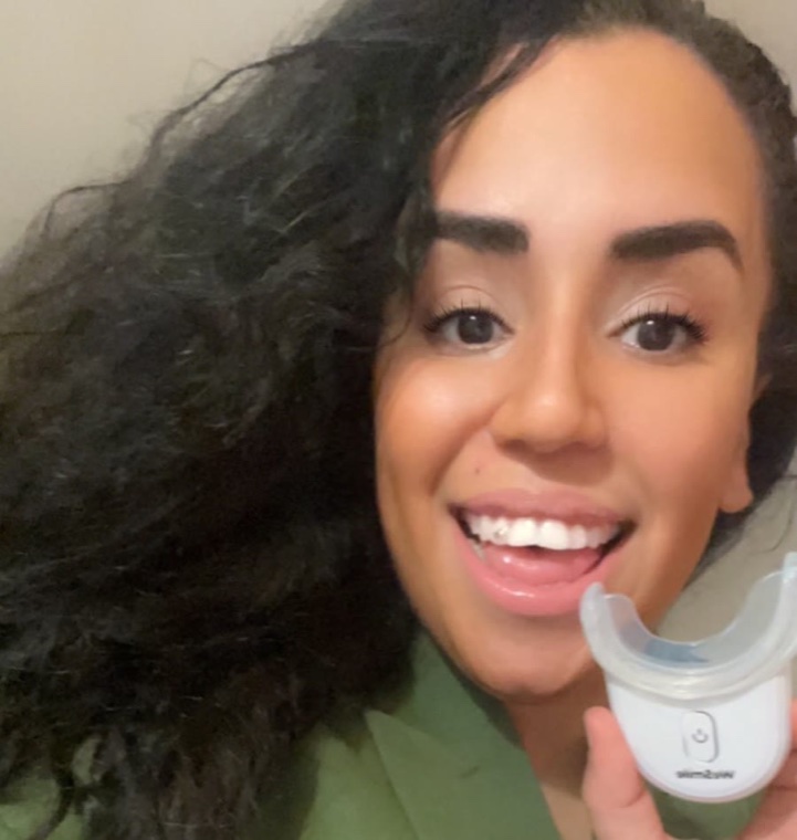 Mohiba Talhaoui smiling and holding up the WeSmile LED tray